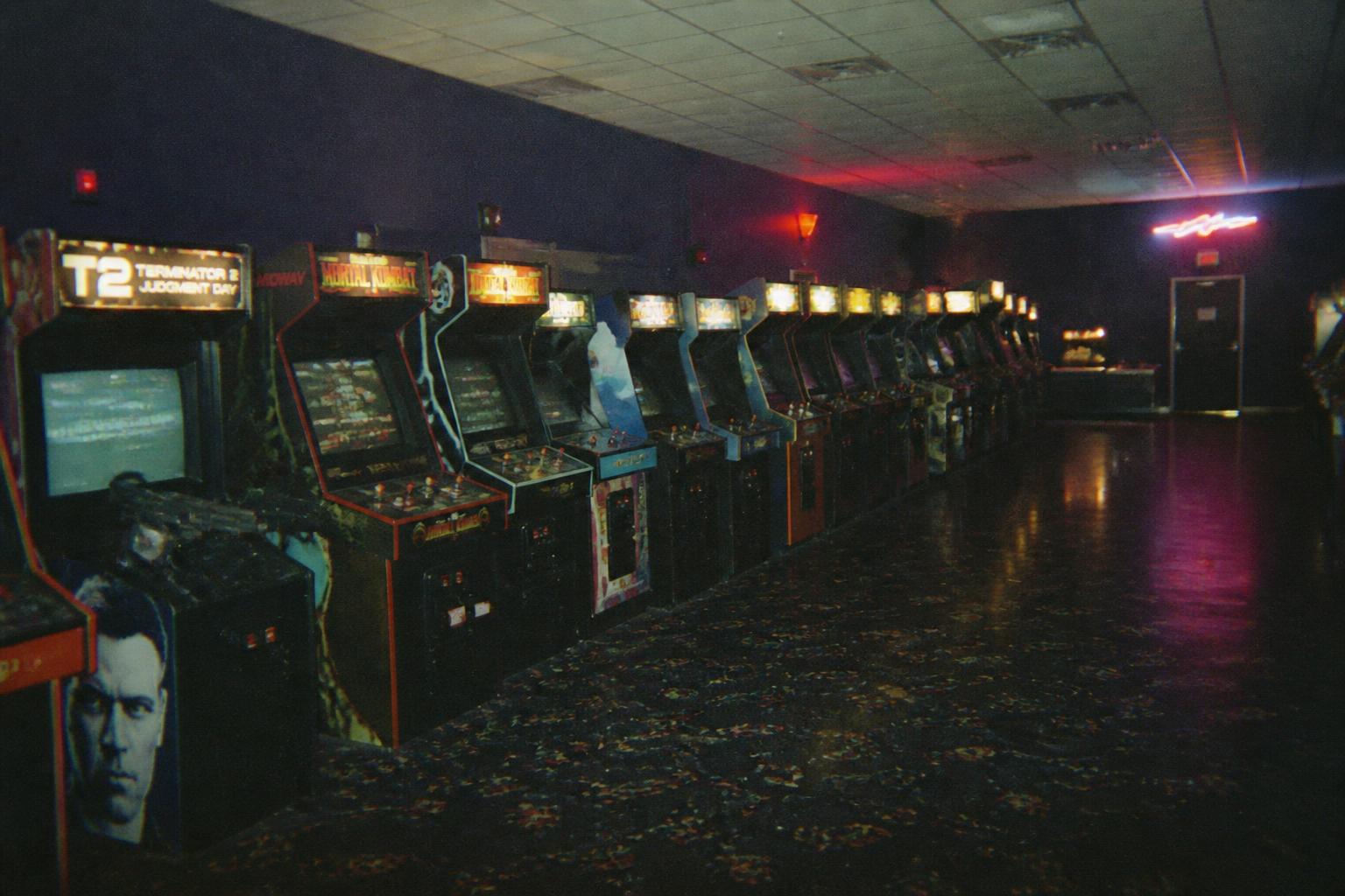 THE ARCADE — Every machine is on. Every machine is waiting.