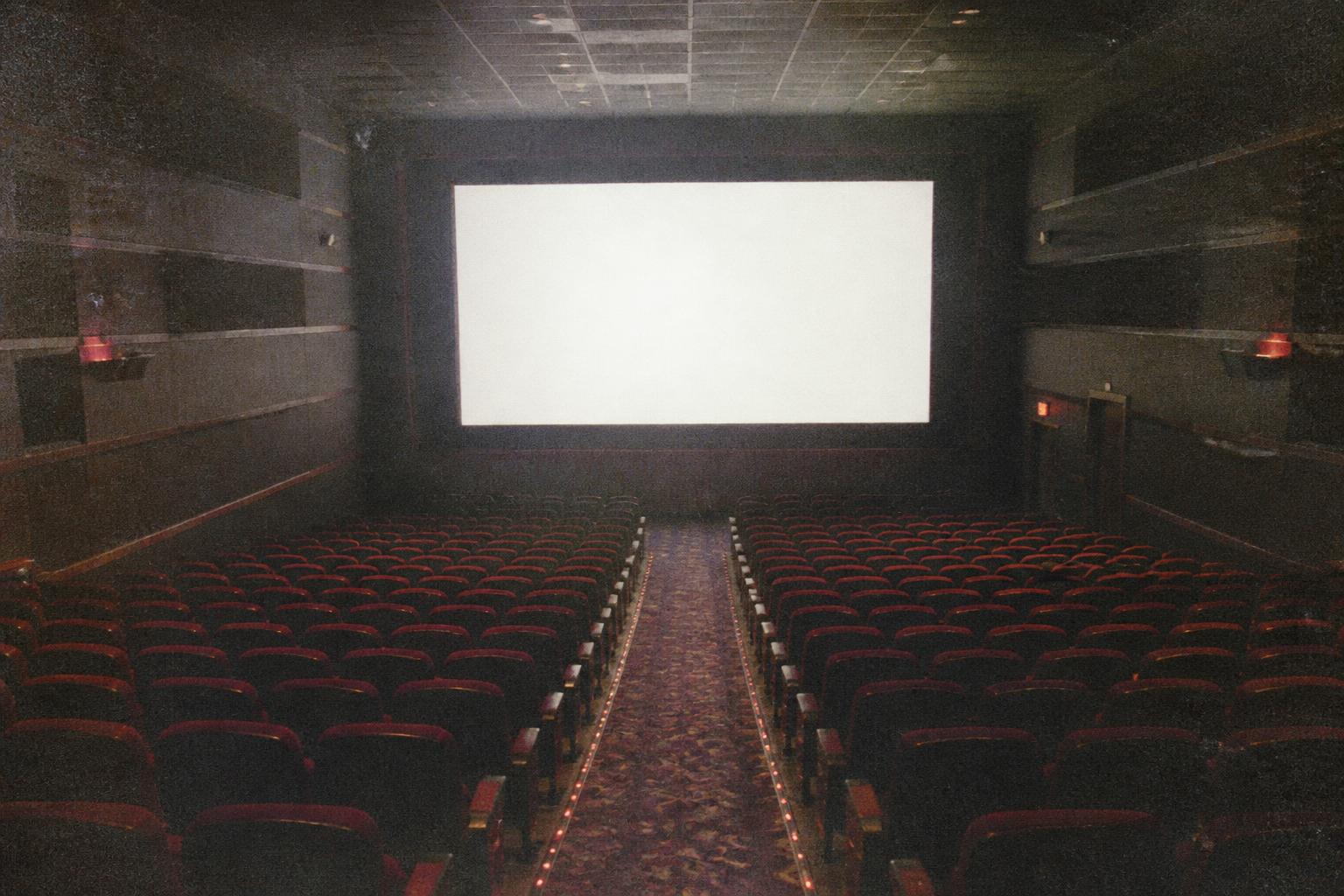 THE MOVIE THEATER — Twenty minutes before anything starts.