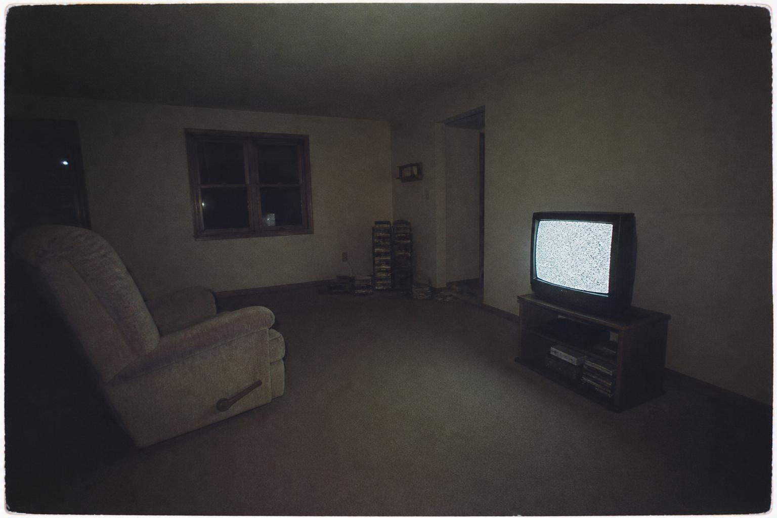 THE ROOM LIT BY TELEVISION — Everyone else is asleep.